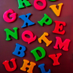 a jumble of brightly coloured capital letters appear against a dark background. 