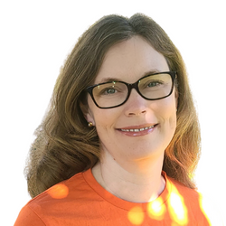 Portrait of Rachel Breau. She is smiling and wearing glasses and an orange shirt.