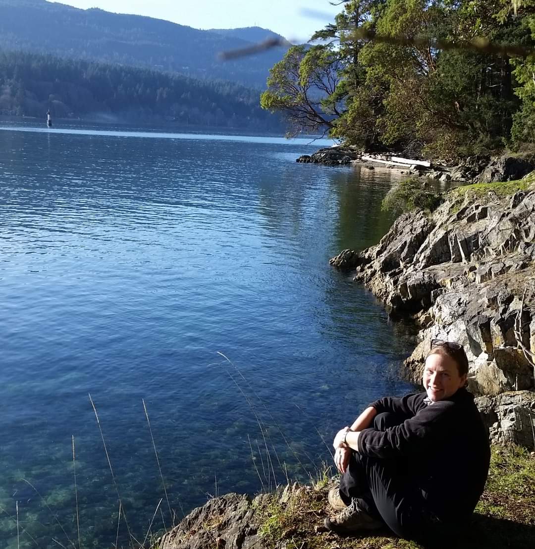 Laurie Davidson sitting near a body of water