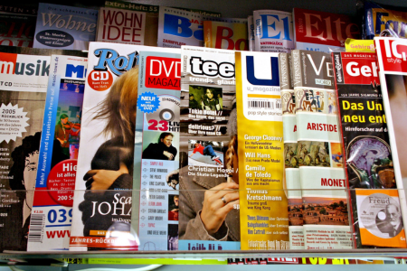 Multiple magazines fanned out and overlapping on a flat surface.
