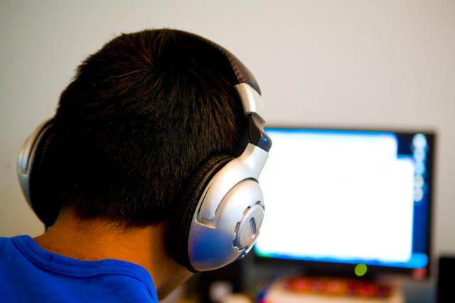 person using headphones at computer