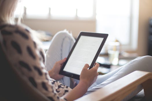 Woman reading with tablet