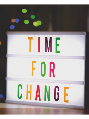 Text on a white sign reads Time for a Change in colourful letters.