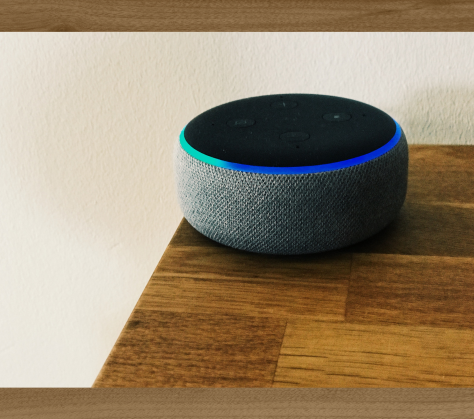 An Amazon Alexa speaker on a wooden table.