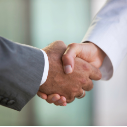 close up of two people shaking hands. 