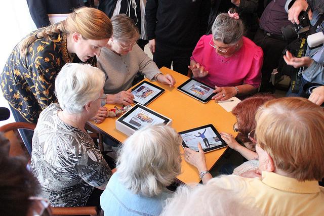 Woman helping another woman with an ipad