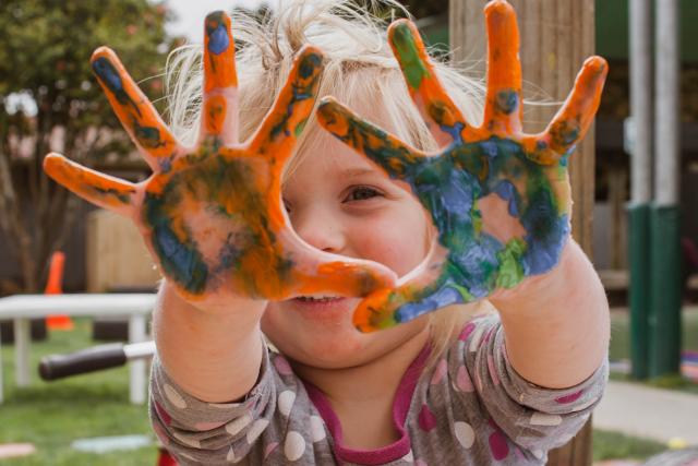 Kid with paint on hands