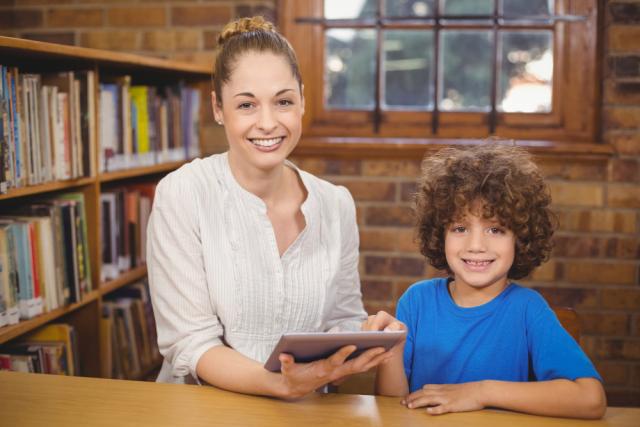 Teacher with student holding ipad