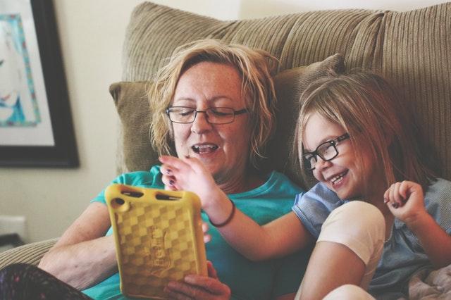 Grandmother and grandchild looking at a tablet