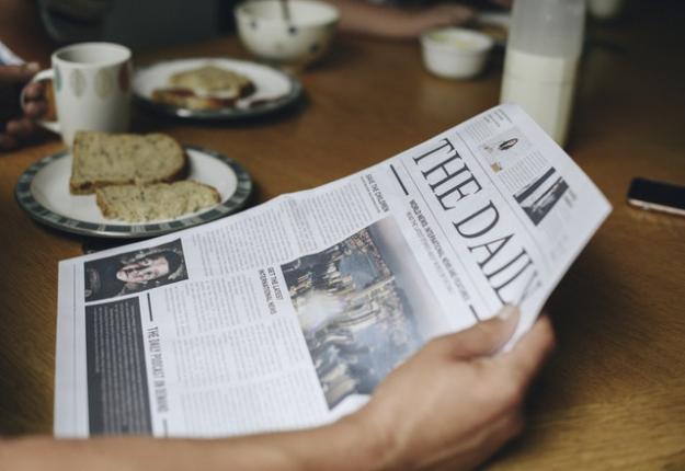 Person reading a newspaper