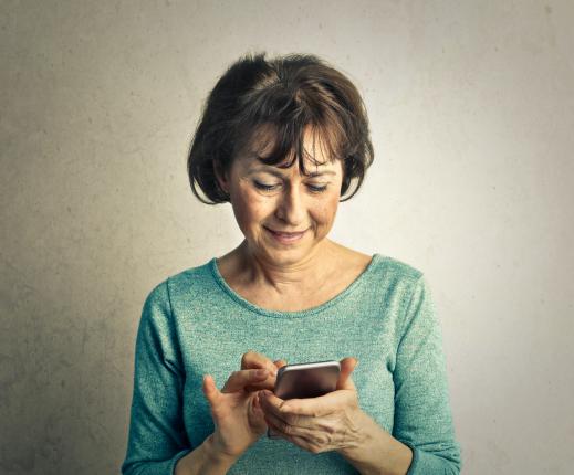 A woman using a smartphone to download books