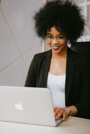 Woman smiling and using computer