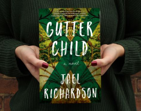 Person holding copy of Gutter child by Jael Richardson