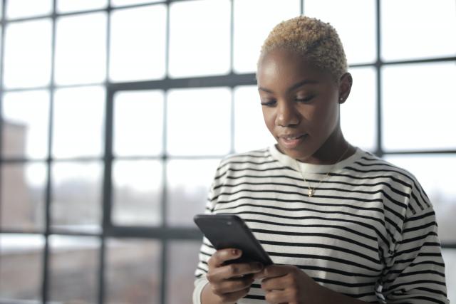 Black woman using iphone to search