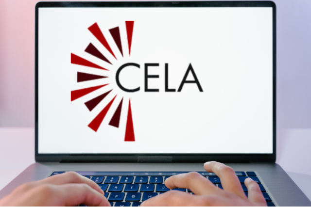 Hands type on a laptop whose monitor shows the CELA logo.